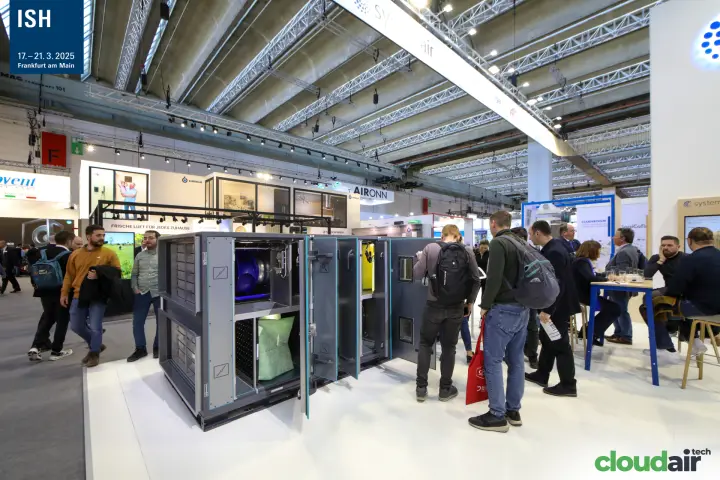 Visitors inspecting an open Systemair air handling unit at the stand edge at ISH 2025