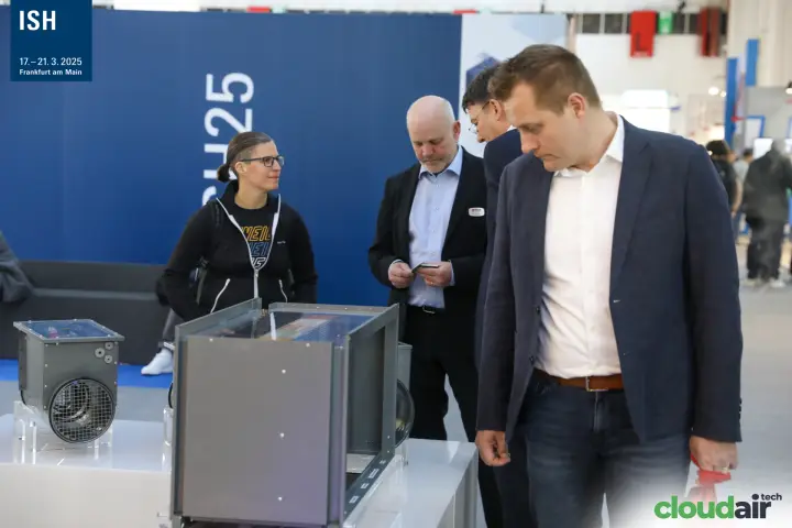 Visitors inspecting VEAB duct heaters with transparent covers