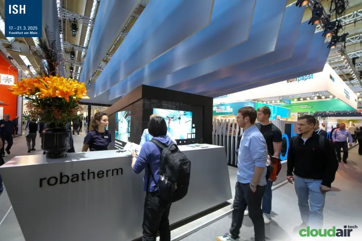 Visitors at the Robatherm reception counter in front of the LED wall at ISH 2025