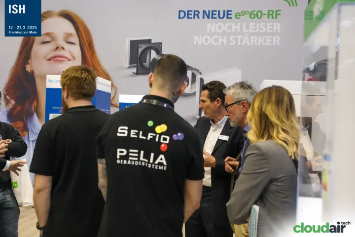 Visitors at the stand presenting the 'Der neue ego60-RF' ventilation unit