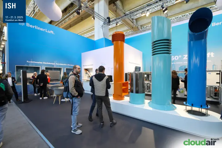 Visitors study BerlinerLuft roof outlets in orange, teal and blue at ISH 2025