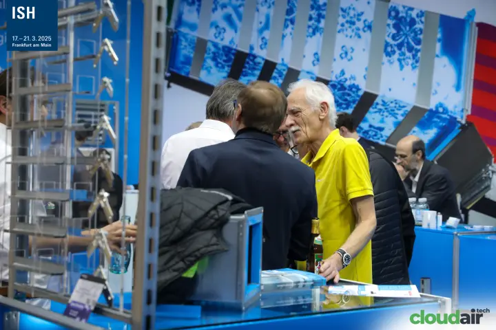 Visitors talking at the Airworker counter beside a display of duct parts