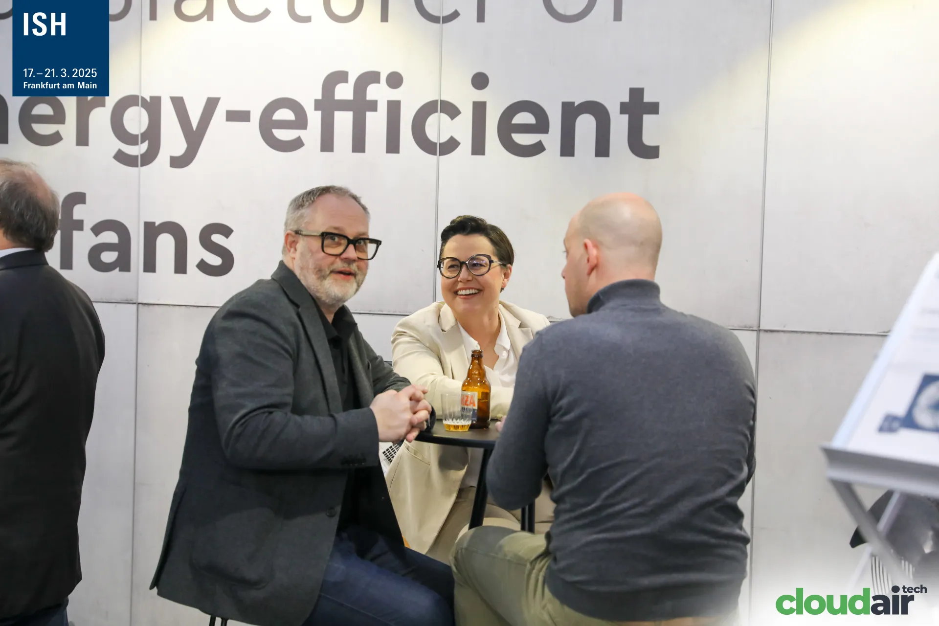 Visitors talking at a bar table on the AFL Motors Europe stand at ISH 2025