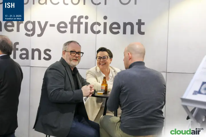 Visitors talking at a bar table on the AFL Motors Europe stand