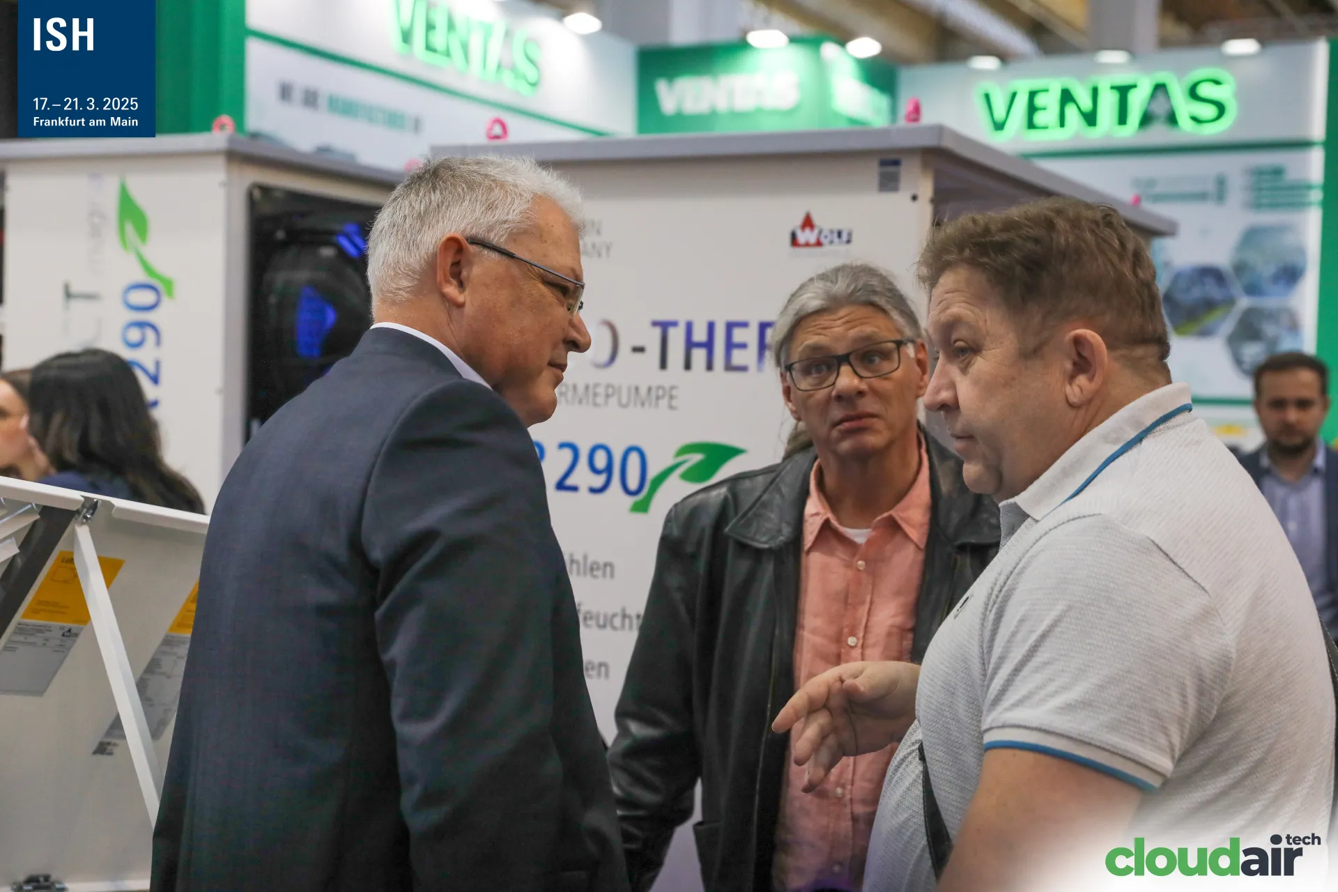 Visitors talking beside Wolf R290 heat pump units at ISH 2025