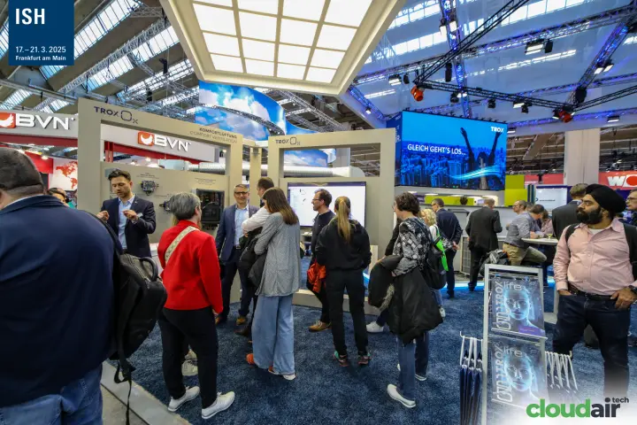 Visitors at the TROX comfort ventilation display under an illuminated ceiling at ISH 2025