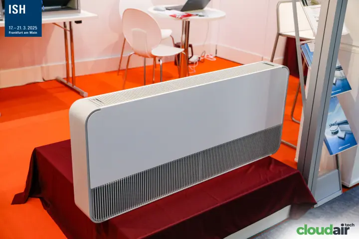 White floor-standing convector on a red-draped plinth