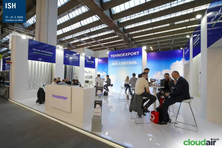Wide view of the Tehnoexport stand with counter and meeting tables at ISH 2025