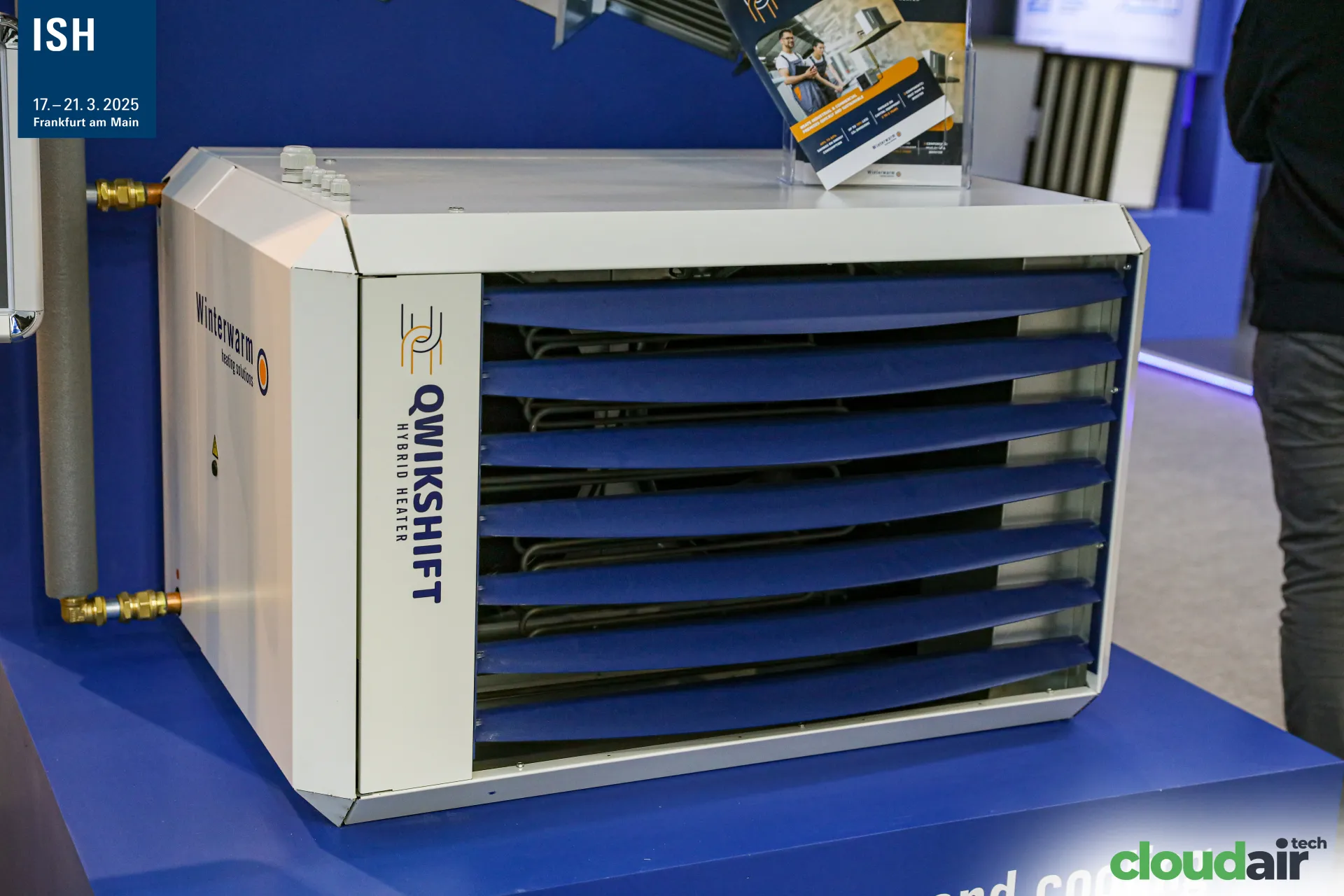 Winterwarm Qwikshift hybrid heater with blue adjustable louvres at ISH 2025