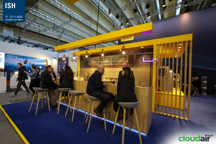 Wooden bar counter with pendant lamps at the Ruck stand at ISH 2025