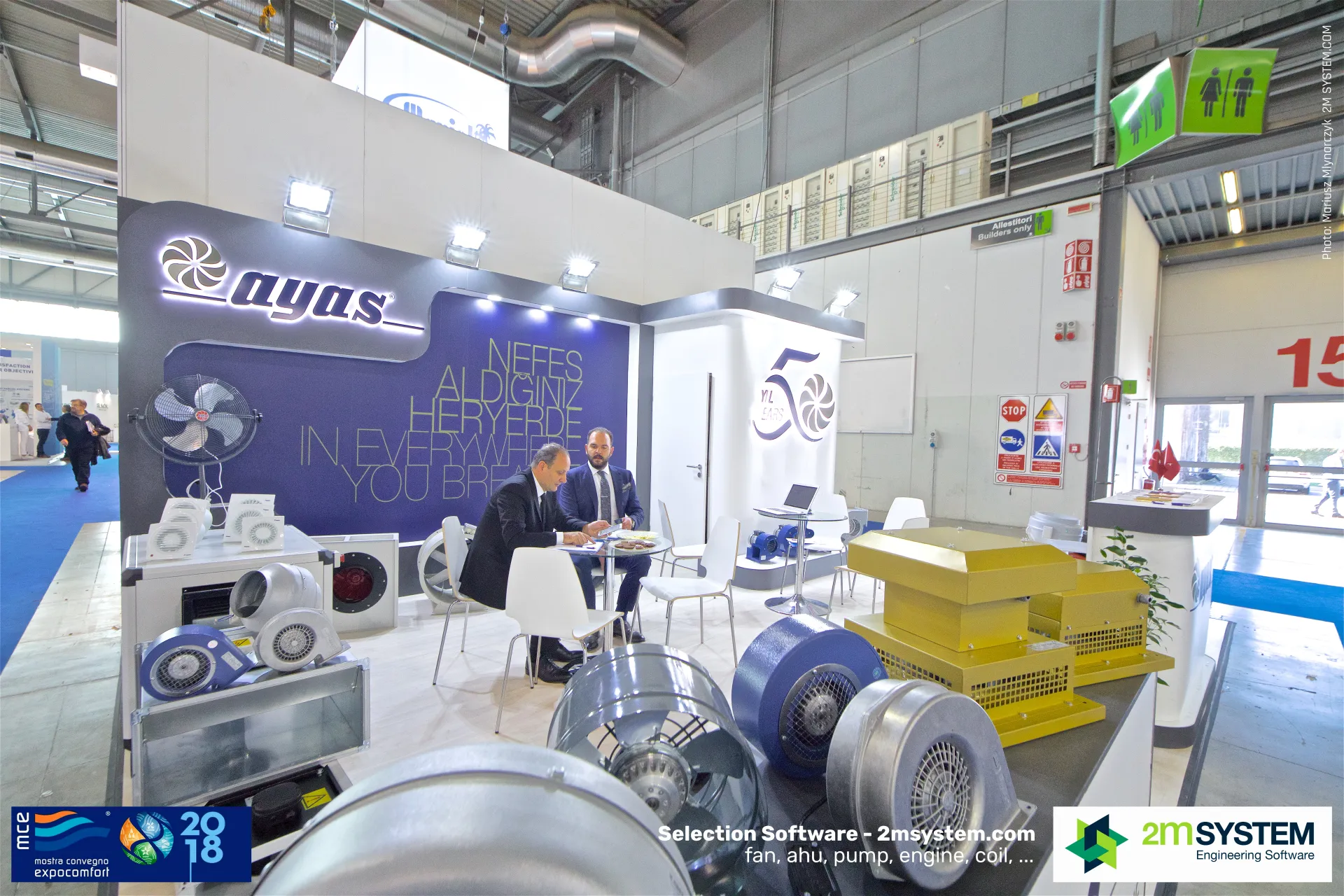 Ayas stand with axial, centrifugal and roof fans around a meeting table at MCE 2018