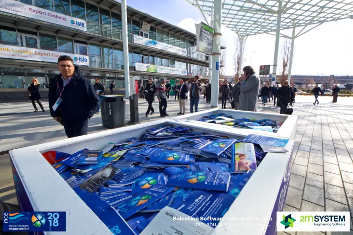 Bin of free MCE 'Guida Pocket' visitor guides and exhibitor leaflets at MCE 2018