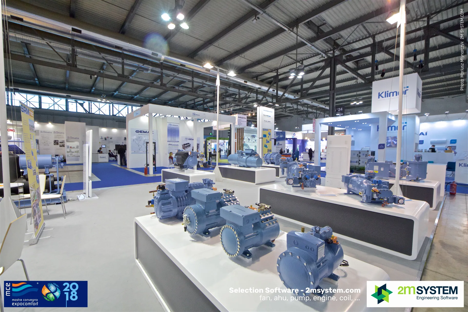 Blue semi-hermetic and screw compressors on white RefComp plinths at MCE 2018