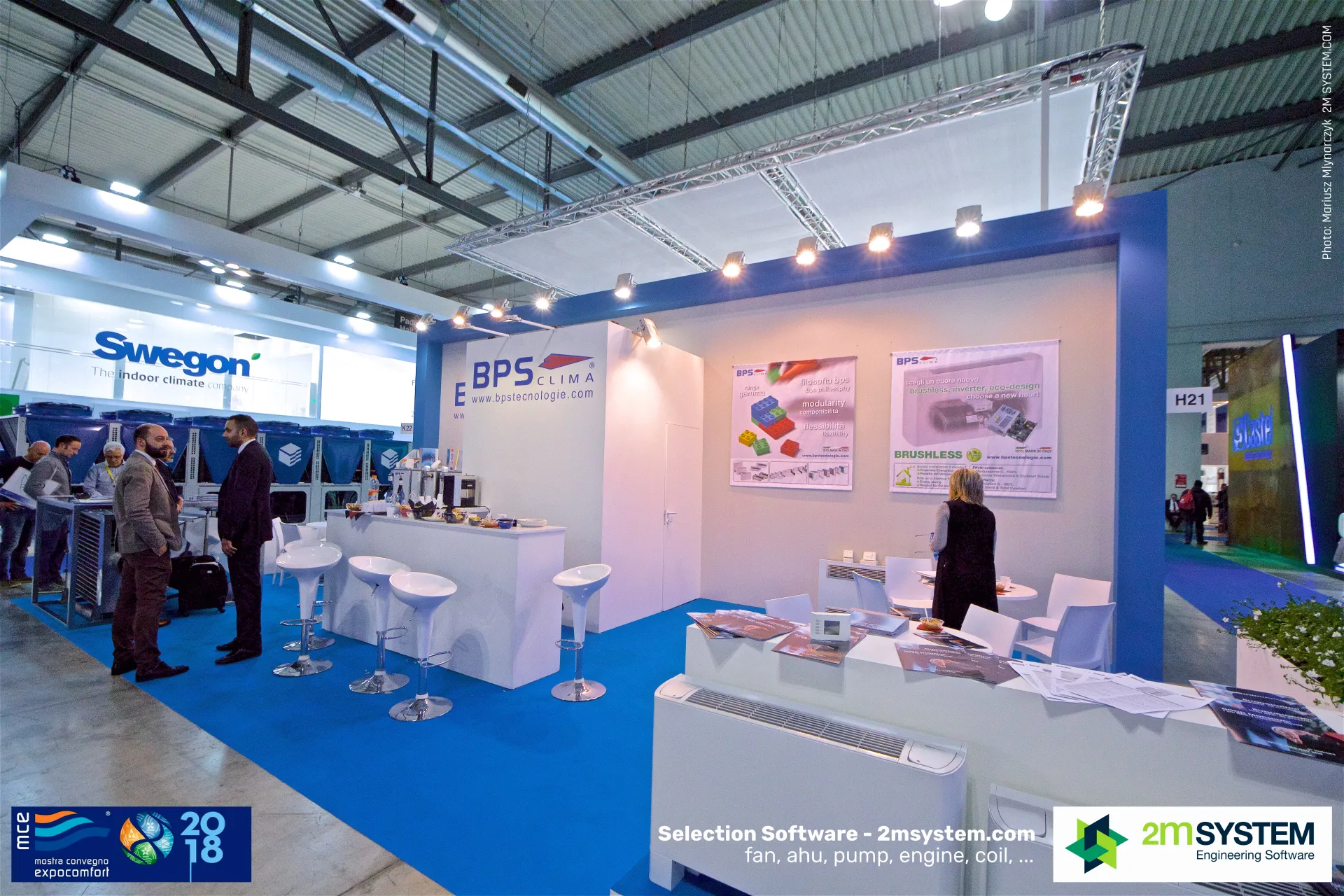 BPS Clima stand with fan coil units and a 'Brushless' inverter poster at MCE 2018