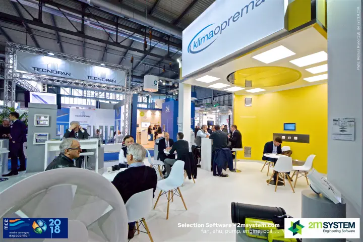 Busy Klimaoprema meeting area with a yellow back wall and white chairs