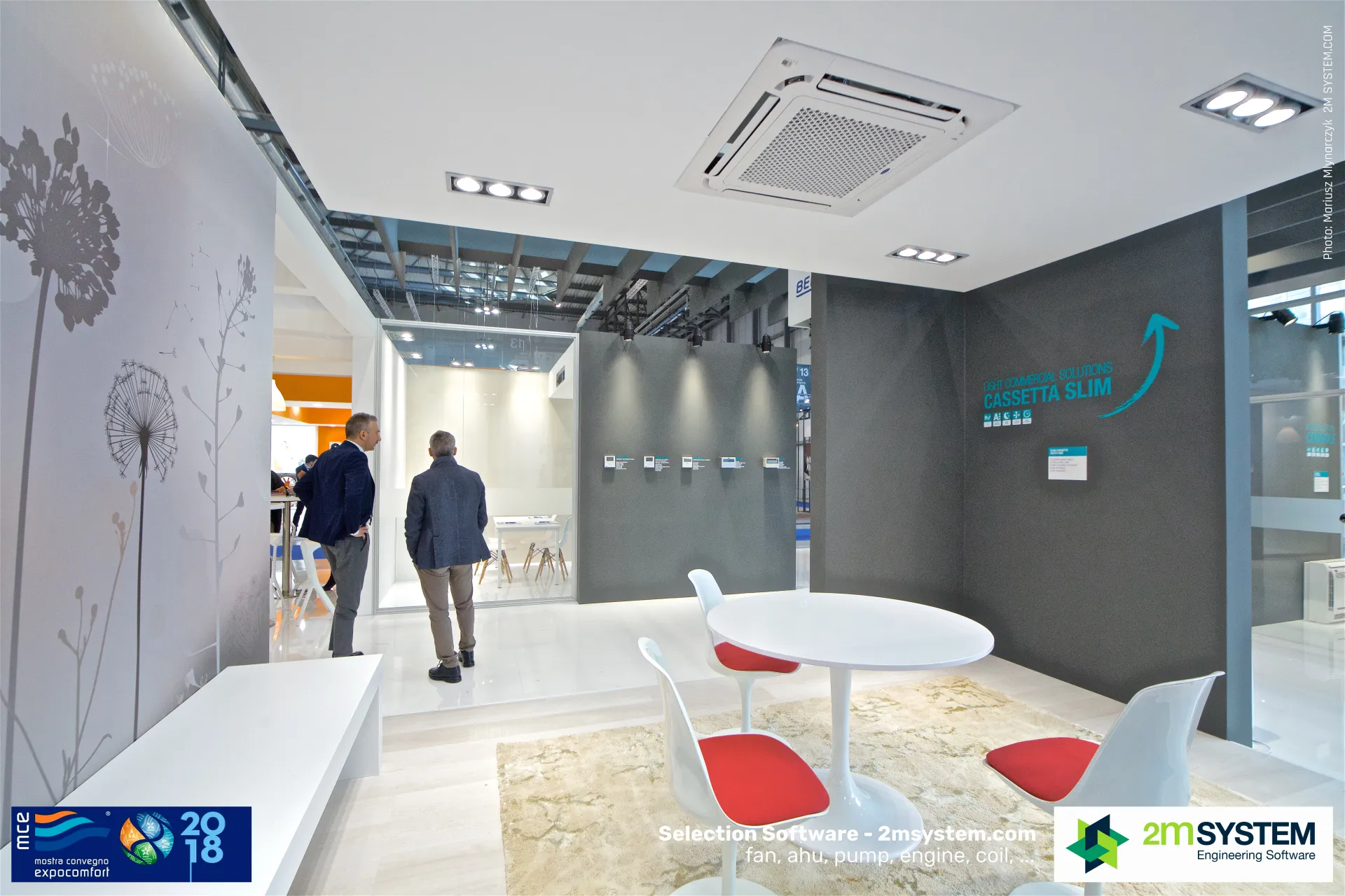 Cassetta Slim ceiling unit above a lounge with red-cushioned tulip chairs at MCE 2018