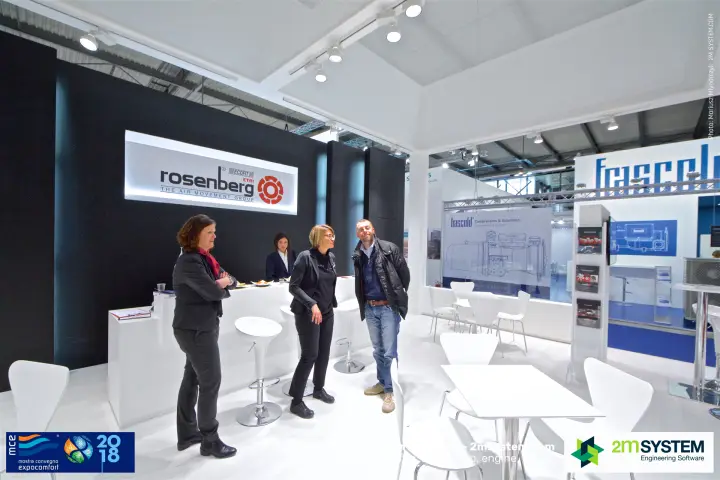 Conversation at the Rosenberg reception under the illuminated logo