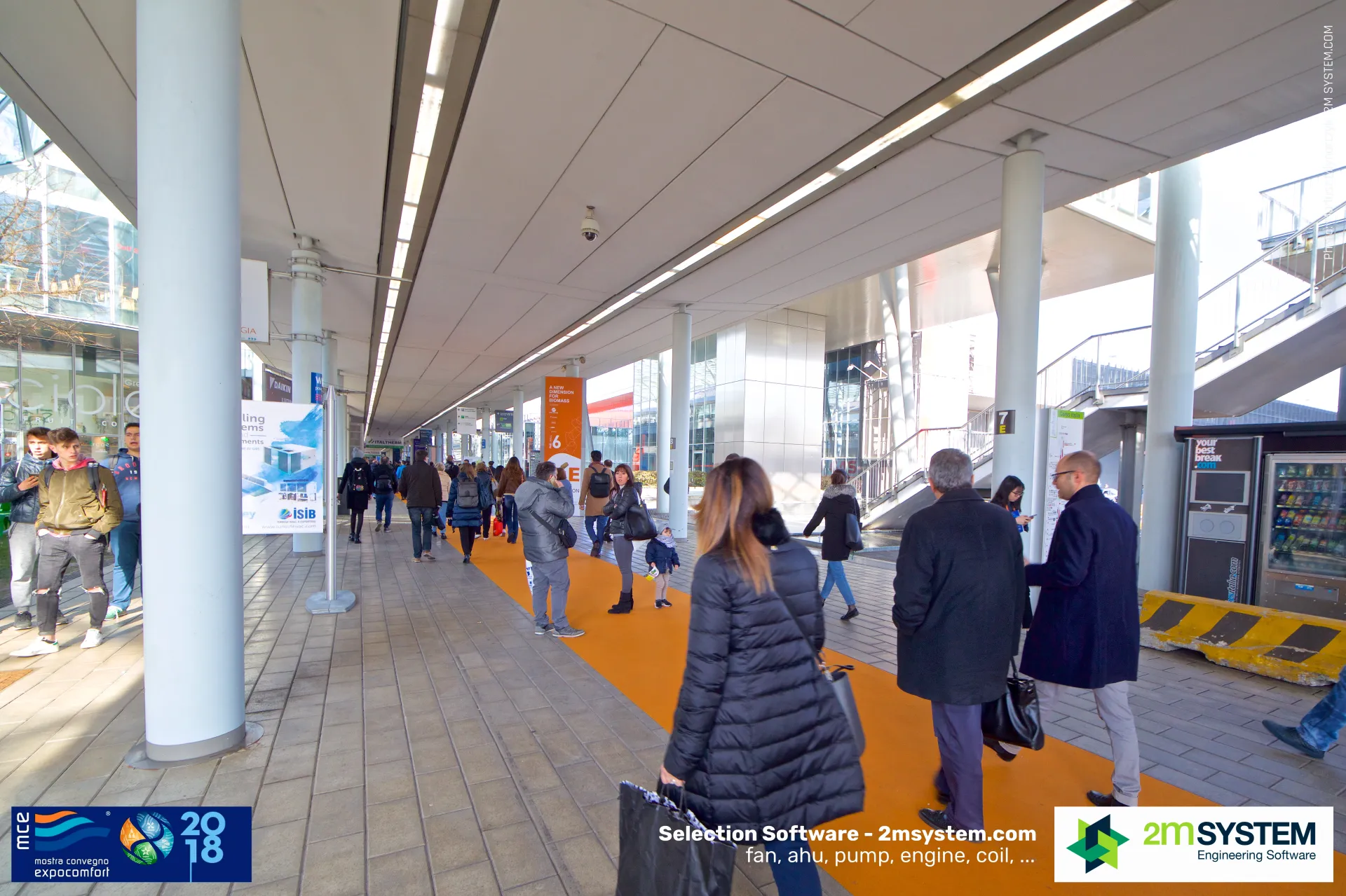 Covered walkway with orange carpet linking halls during MCE 2018
