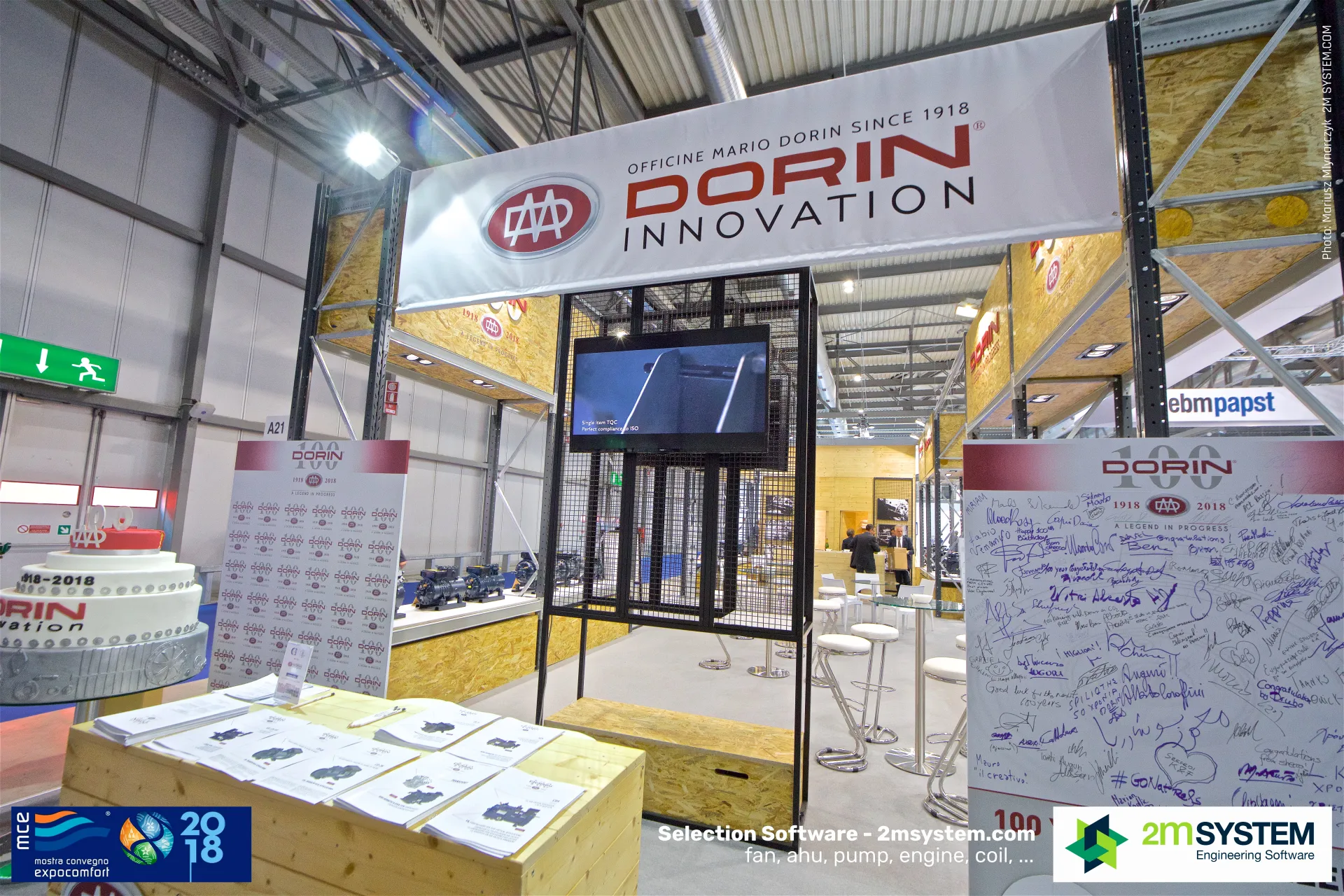 Dorin centenary entrance with anniversary cake and a signed greetings wall at MCE 2018