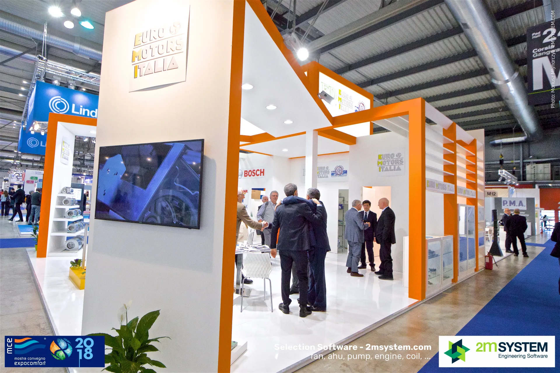 Euro Motors Italia stand with orange frames and greeting visitors at MCE 2018