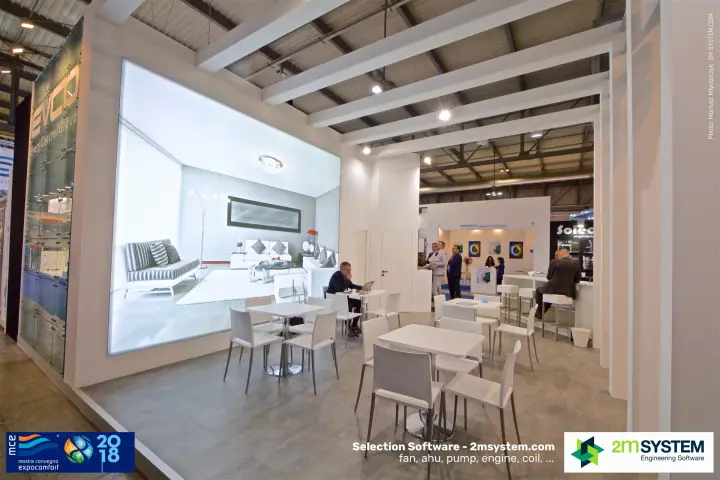 EVCO stand lounge with backlit interior image and white tables at MCE 2018