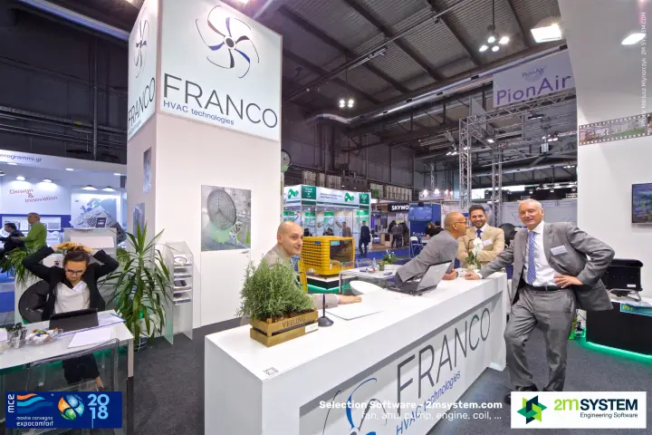 Franco stand team at the white counter under the logo tower