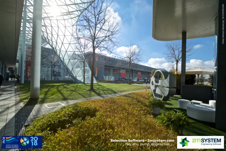 Garden lounge with white seating and grey sculpture beside the canopy at MCE 2018
