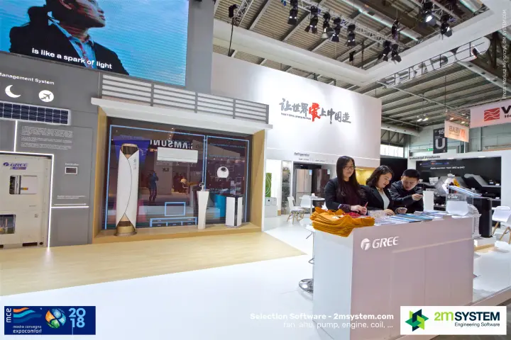 Gree desk and glass showroom room under a large video wall