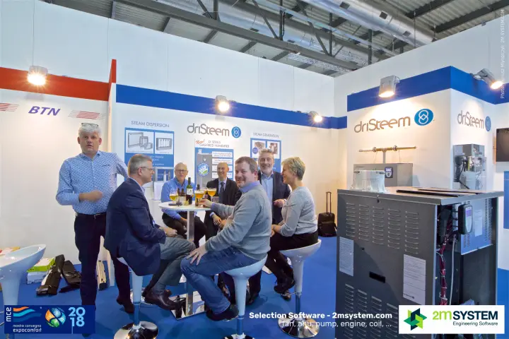 Group gathered around a table at the DriSteem humidification stand at MCE 2018