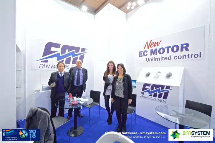 Group photo at the FMI stand under the "New EC Motor" sign