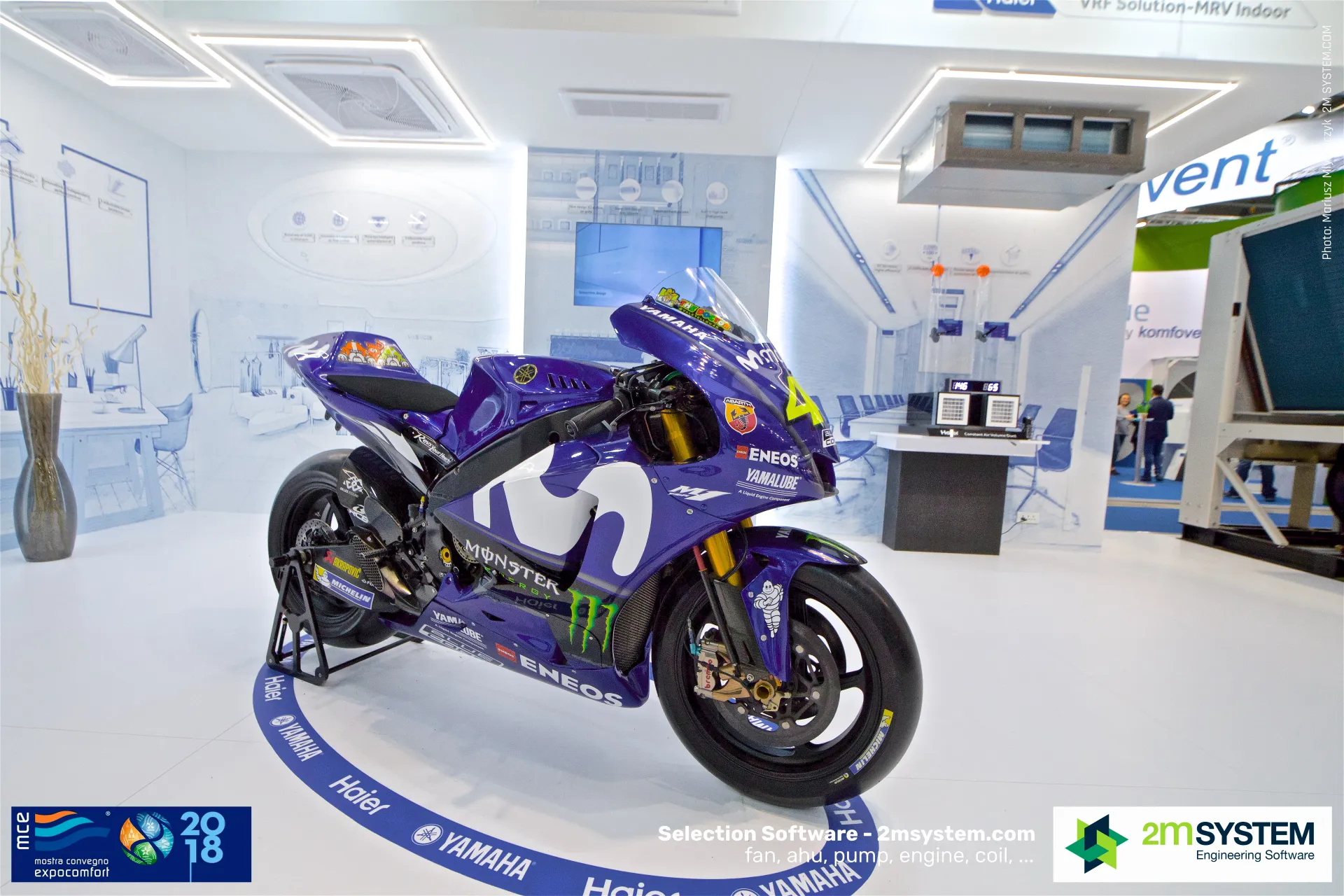 Haier MRV indoor showroom with cassette units behind the Yamaha bike at MCE 2018