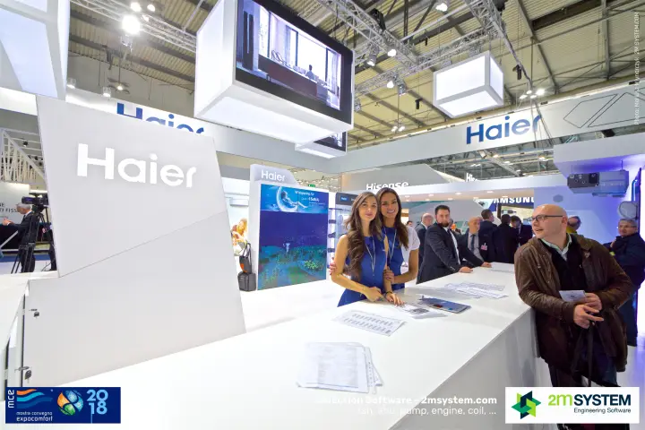 Haier staff posing at the white reception desk
