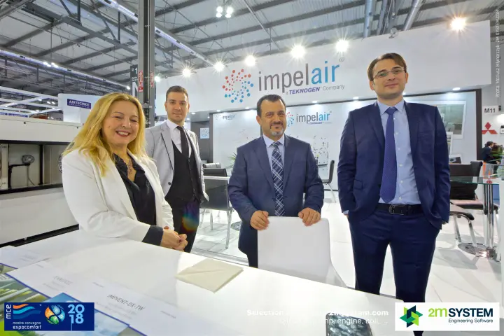 Impelair staff with Impvent-DX-TW heat recovery brochure