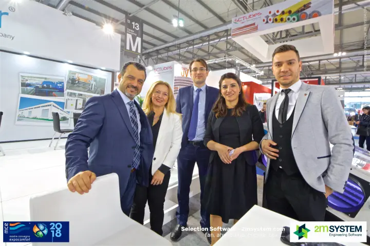 Impelair team group photo in front of factory photographs