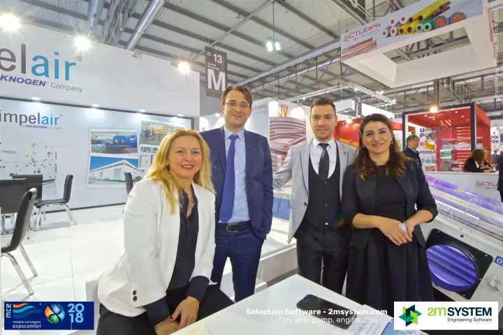 Impelair team portrait beside a UV-lit air unit at MCE 2018