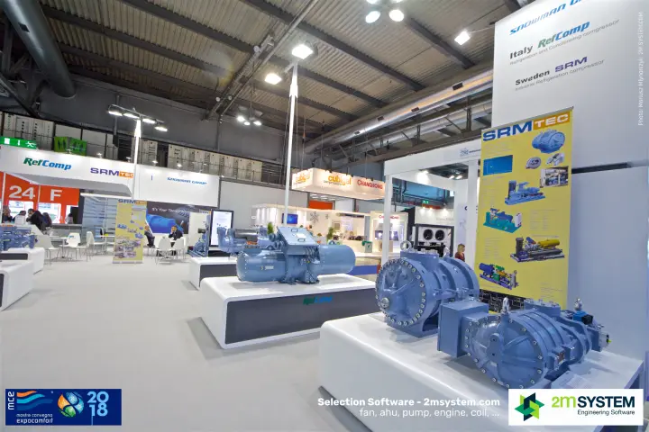 Industrial screw compressors next to an SRMTec banner on the RefComp stand at MCE 2018