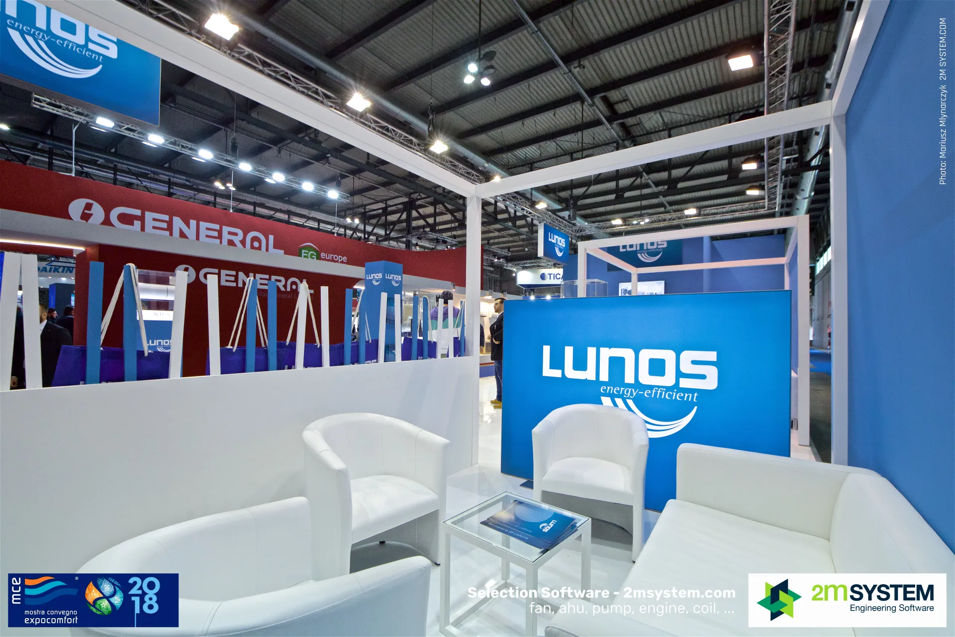 Lunos lounge area with white armchairs and blue logo panel at MCE 2018