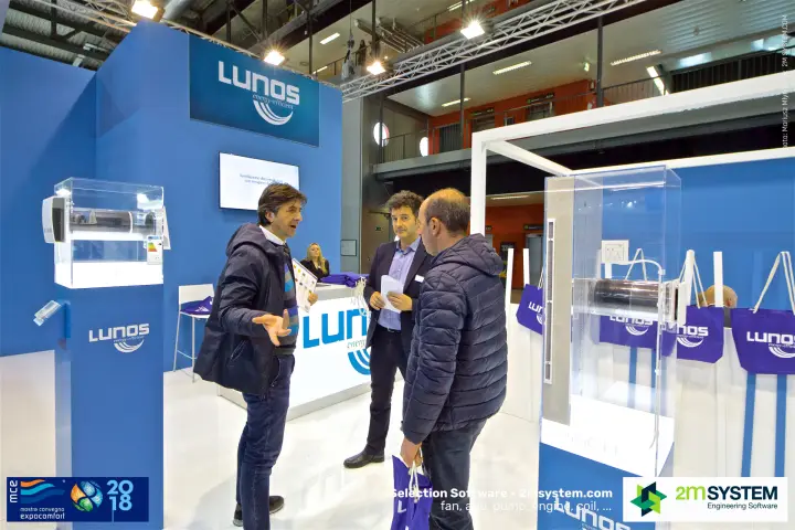 Lunos staff discussing decentralised ventilation with visitors
