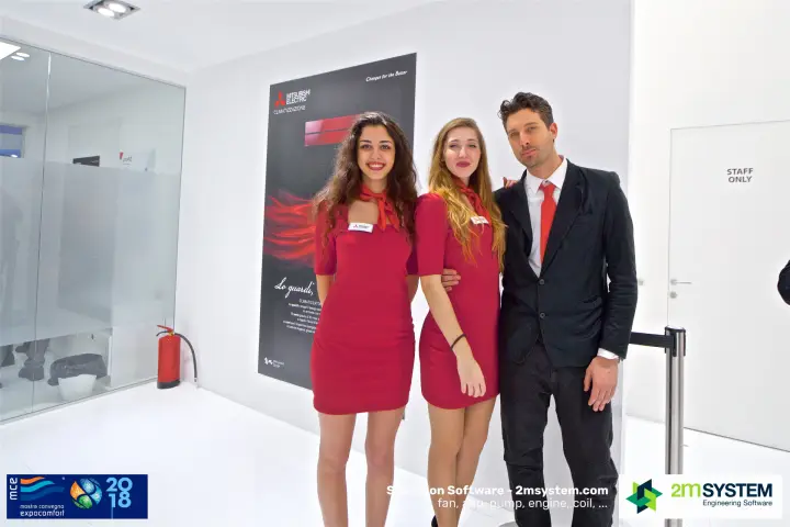 Mitsubishi Electric stand team posing beside a Climatizzazione poster