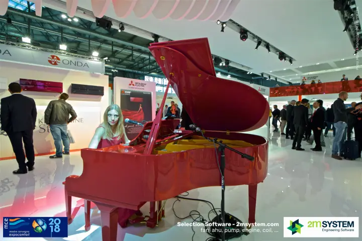 Pianist at the red grand piano beside Kirigamine Style indoor units at MCE 2018
