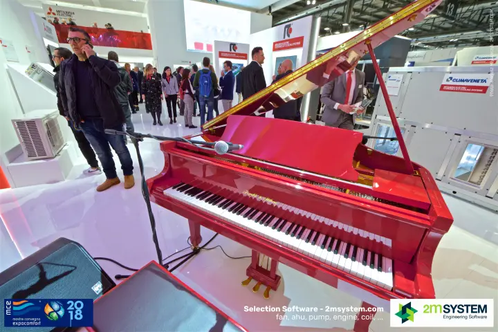 Red grand piano on the Mitsubishi Electric stand beside Climaveneta units at MCE 2018