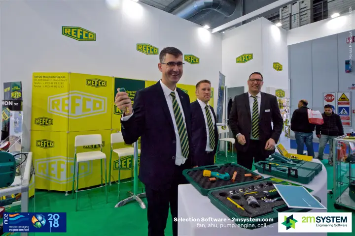 Refco staff holding up a hand tool next to open tool kits at MCE 2018