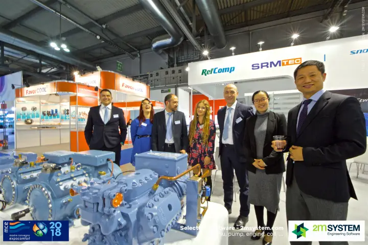 RefComp staff and guests beside compressors with copper piping at MCE 2018