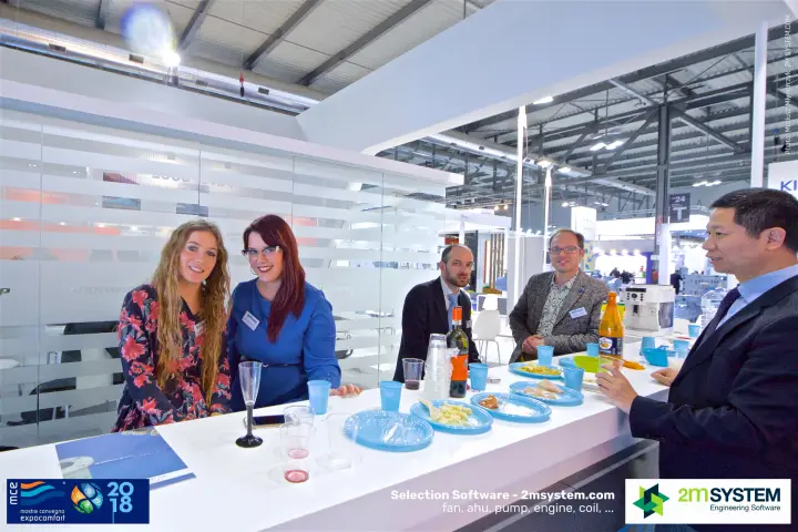 RefComp staff and guests at the stand's white bar counter at MCE 2018