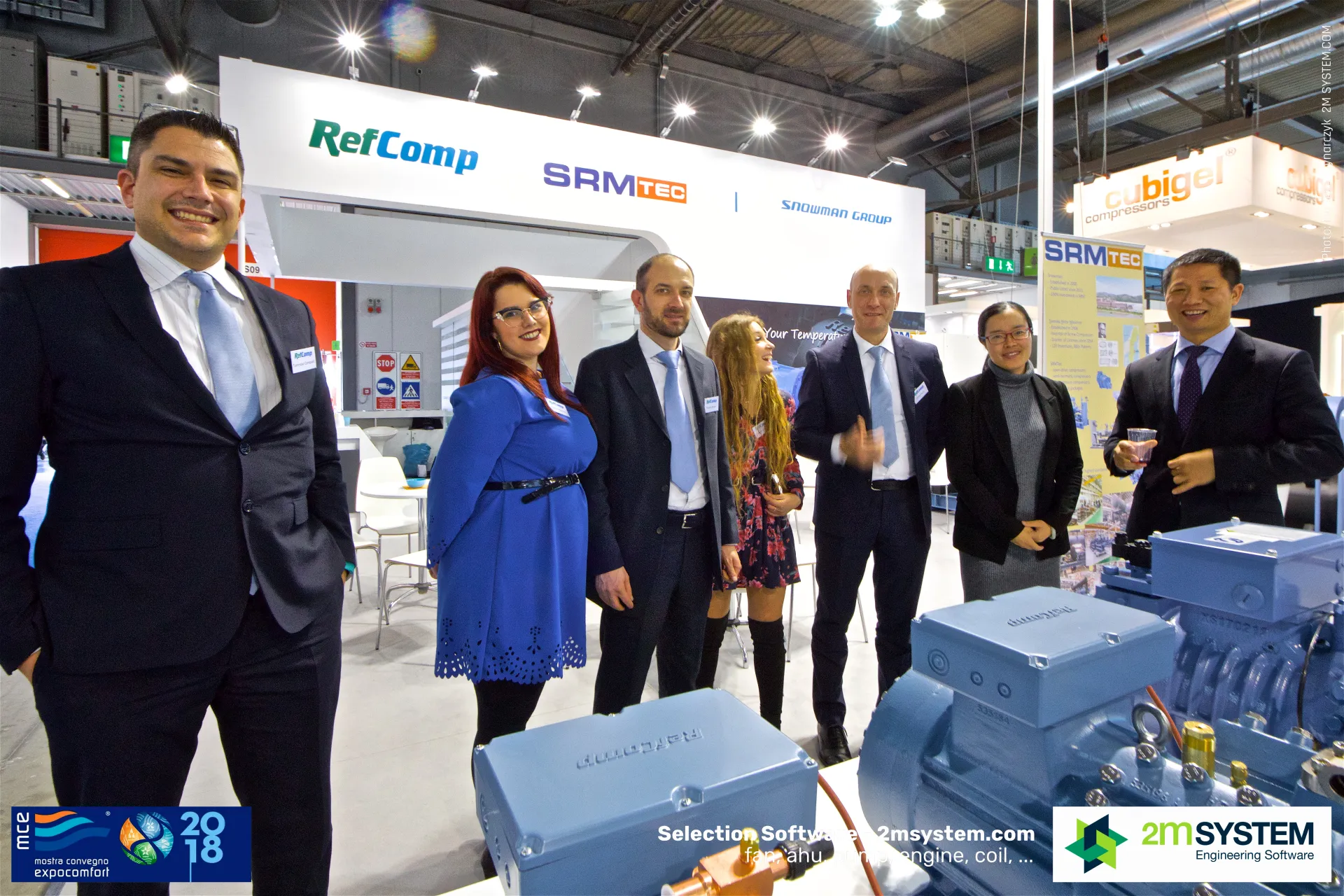 RefComp team with an embossed compressor terminal box in front at MCE 2018