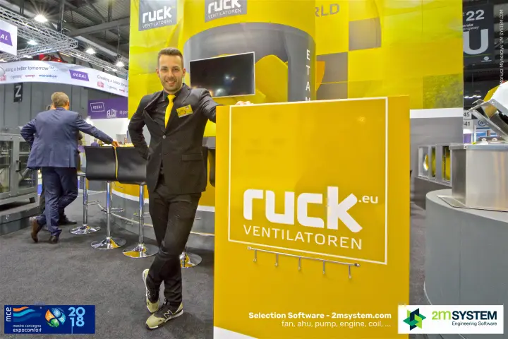Ruck staff member beside the yellow ruck.eu Ventilatoren pillar at MCE 2018