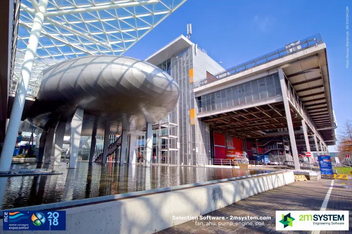 Silver pod building and hall 6 facade beside the reflecting pool at MCE 2018