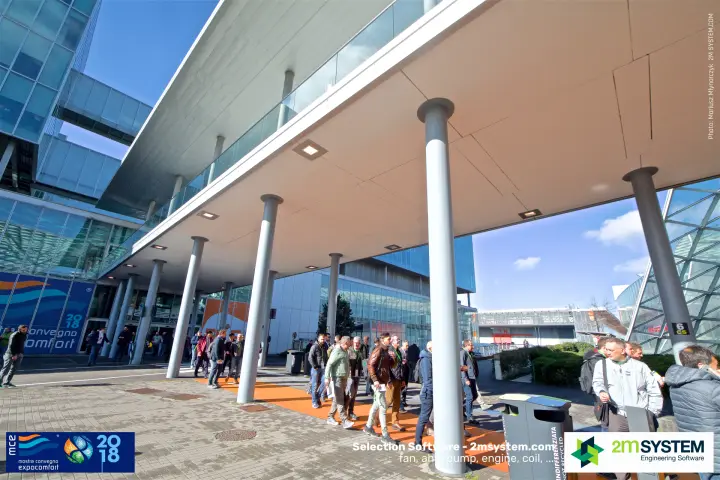 Visitor flow on the orange path beneath the raised walkway, hall 6 marker at MCE 2018