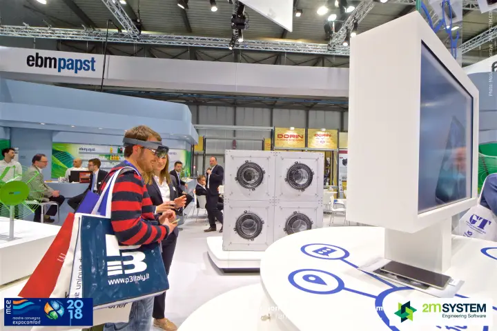 Visitor tries an augmented-reality headset at the ebm-papst interactive table at MCE 2018