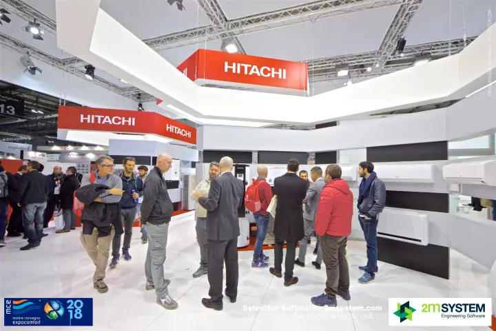 Visitors crowding the Hitachi stand under red hanging signs at MCE 2018